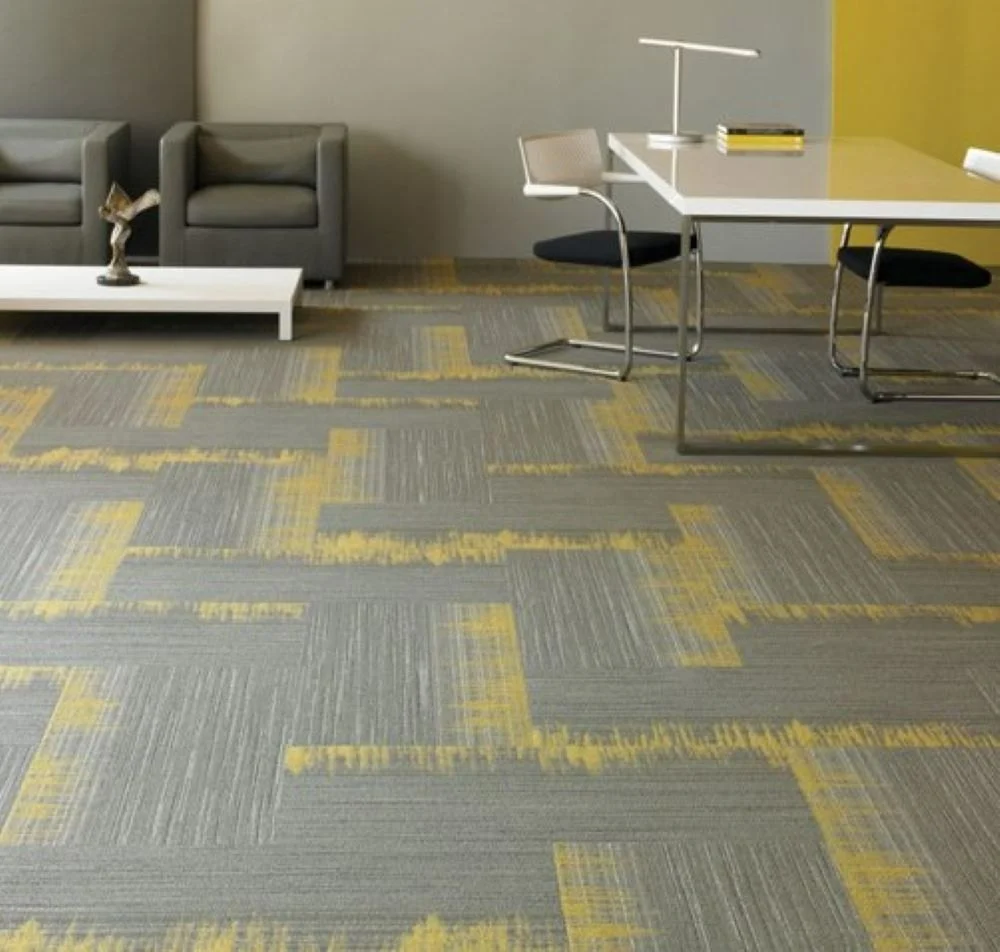 grey and yellow carpet tile in room with chairs and desk 
