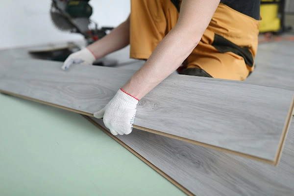 LVT Installation with plank tile being placed