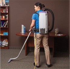 Person cleaning carpet with vacuum