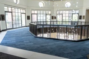 blue commercial carpet tile installation in municipal theater landing