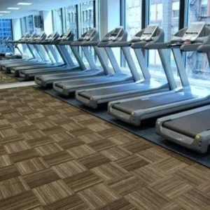 Flexco's FlexTuft recycled rubber tile witha row of treadmills in a gym