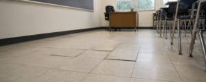 VCT floor tile showing signs of moisture damage Vinyl flooring lifting from moisture-damaged subfloor.