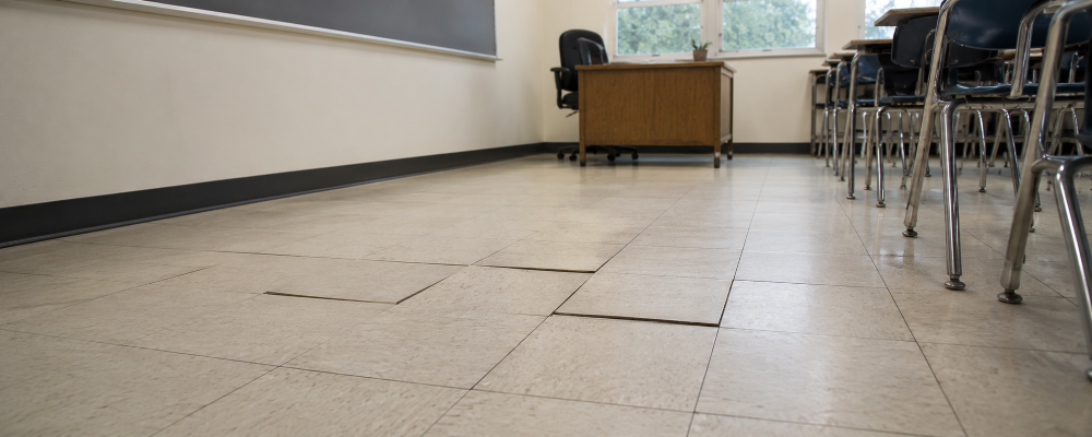 VCT floor tile showing signs of moisture damage Vinyl flooring lifting from moisture-damaged subfloor.